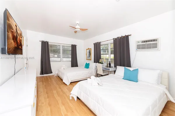 a bedroom with a large bed and a flat screen tv