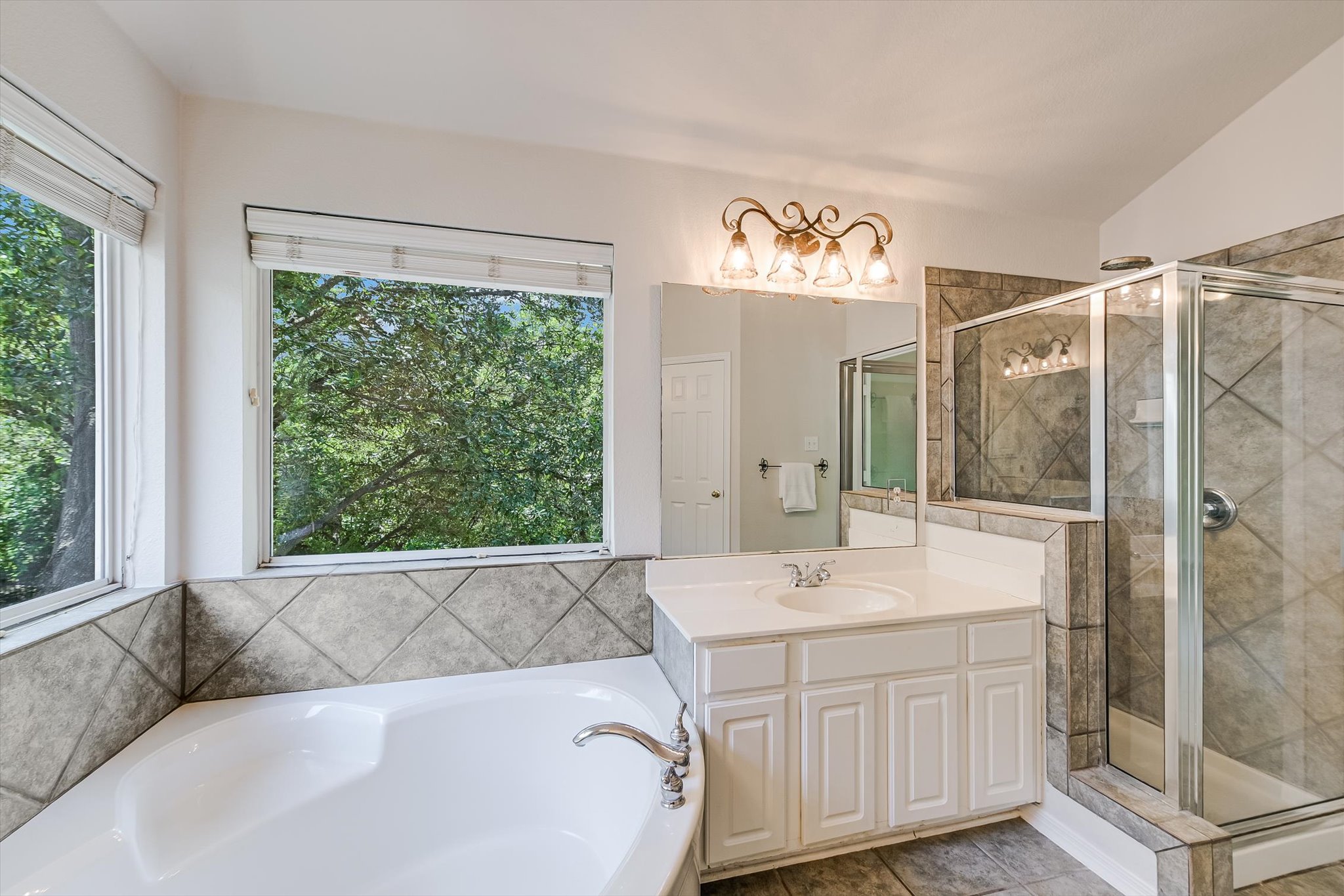 2849 Grimes Ranch Road Austin, TX 78732 - Photo 21 of 31 Corner soaking tub and a separate glass-enclosed shower create a serene bathing oasis.