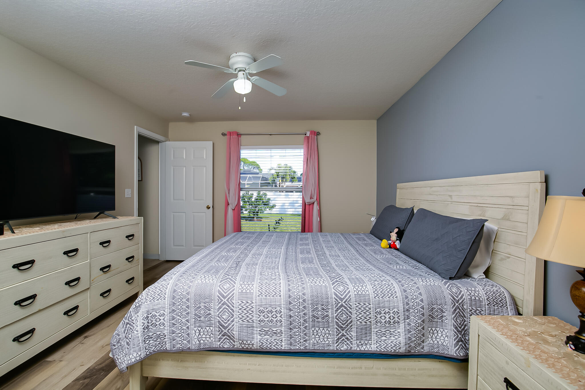 2065 Southwest Gemini Lane Port St. Lucie, FL 34984 - Photo 15 of 24 a bed sitting in a bedroom and flat screen tv