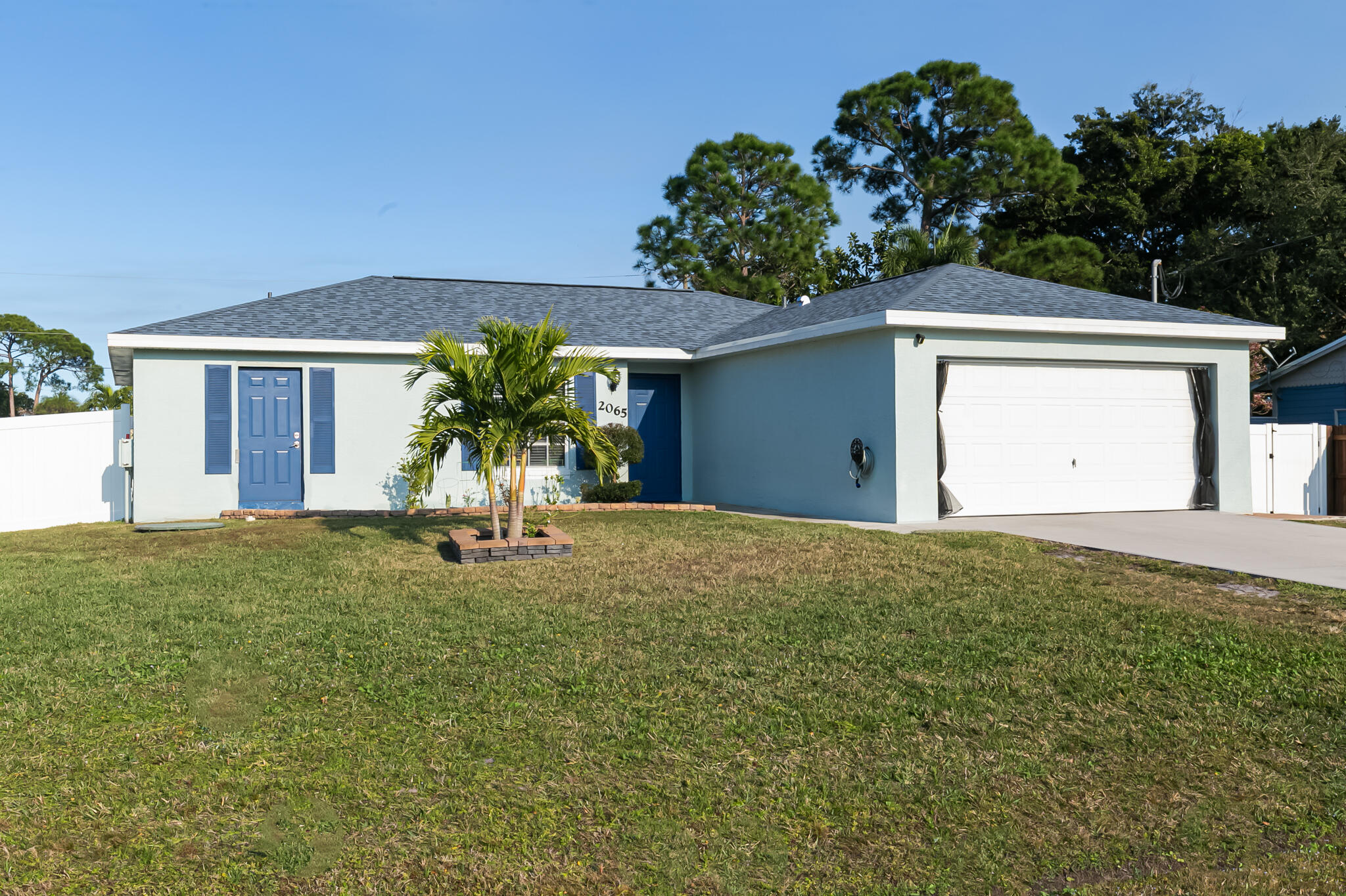 2065 Southwest Gemini Lane Port St. Lucie, FL 34984 - Photo 2 of 24 a view of a house with a yard and a garden