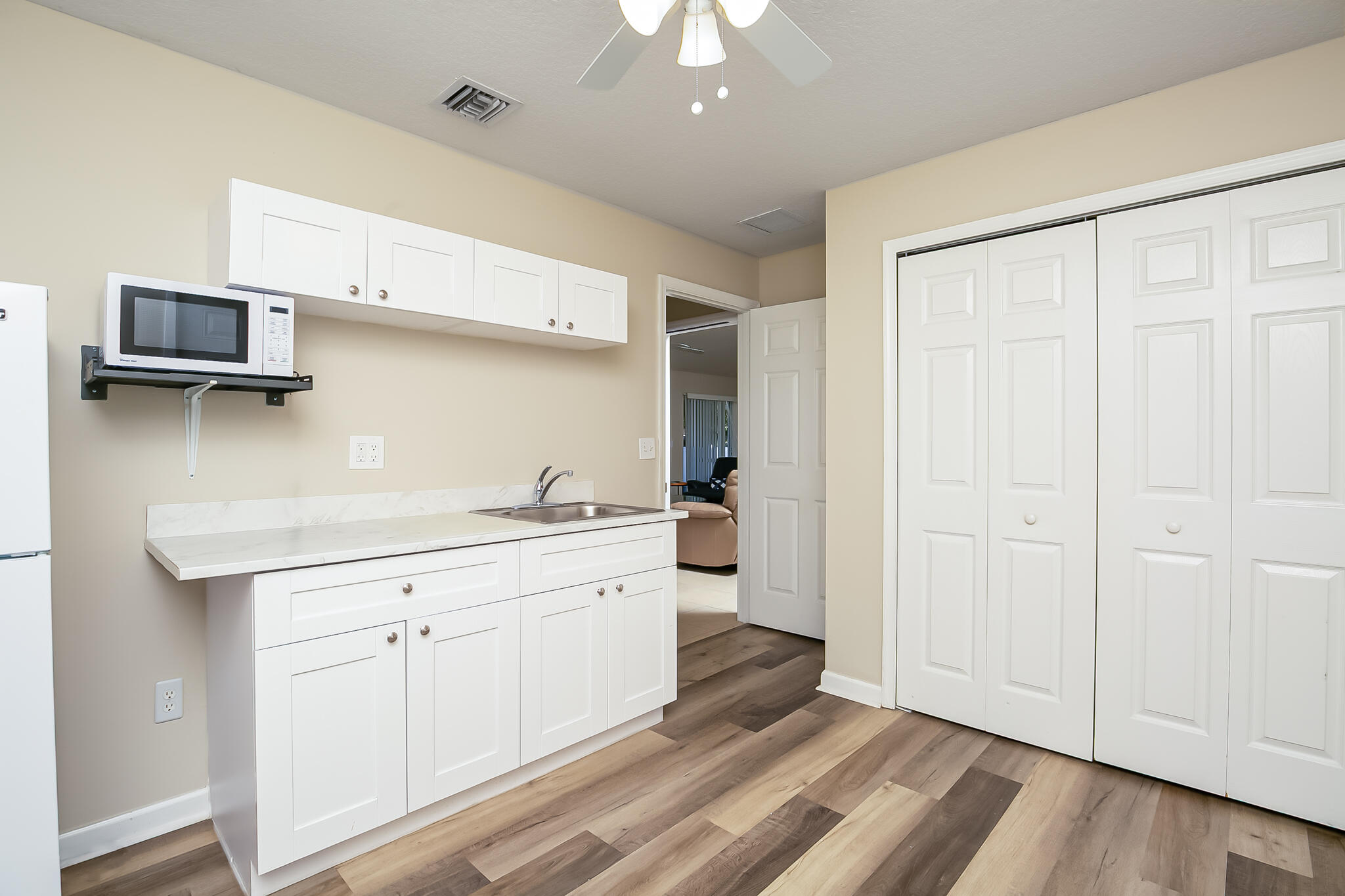2065 Southwest Gemini Lane Port St. Lucie, FL 34984 - Photo 21 of 24 a kitchen with a sink and a stove top oven