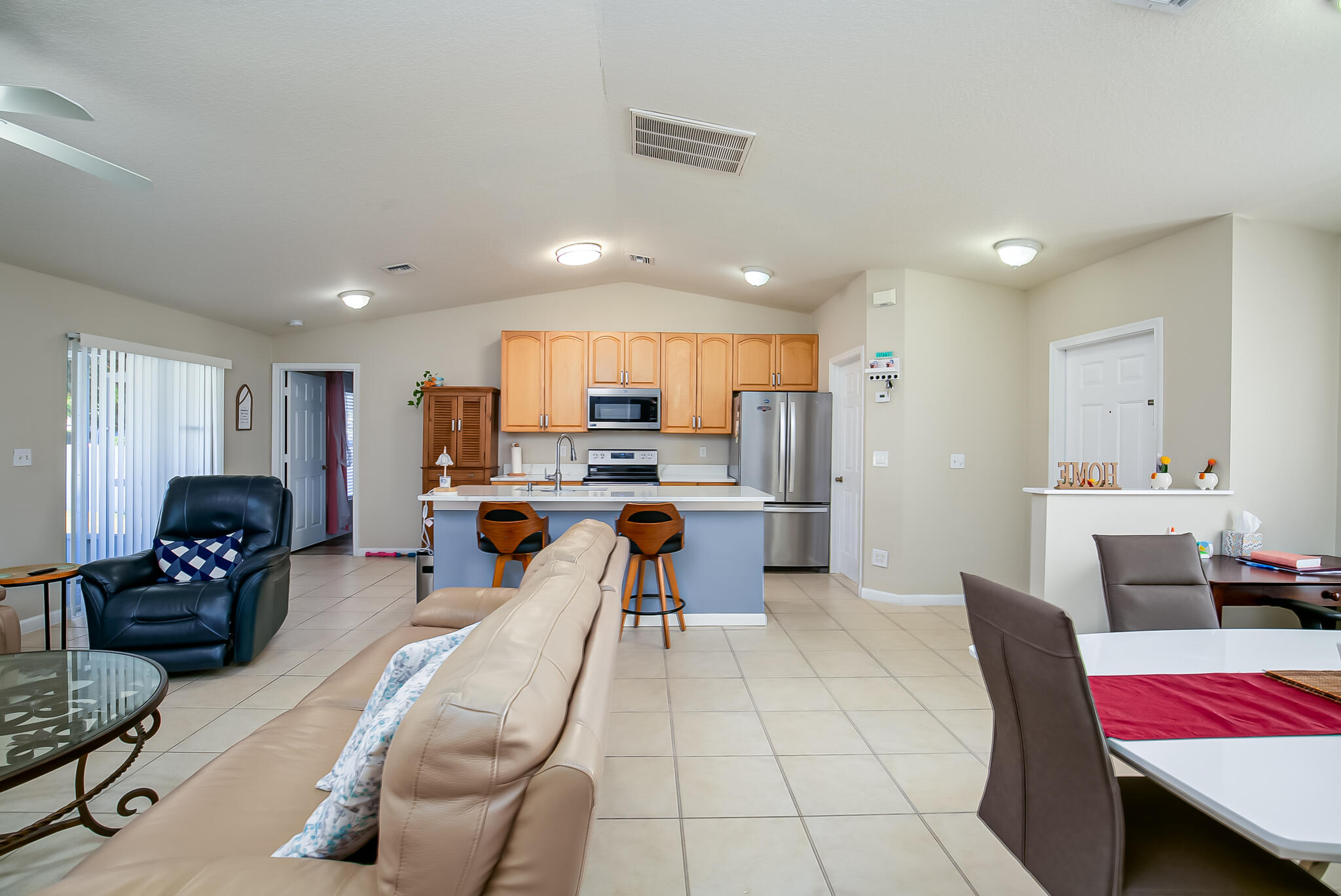 2065 Southwest Gemini Lane Port St. Lucie, FL 34984 - Photo 5 of 24 a living room with furniture and kitchen view