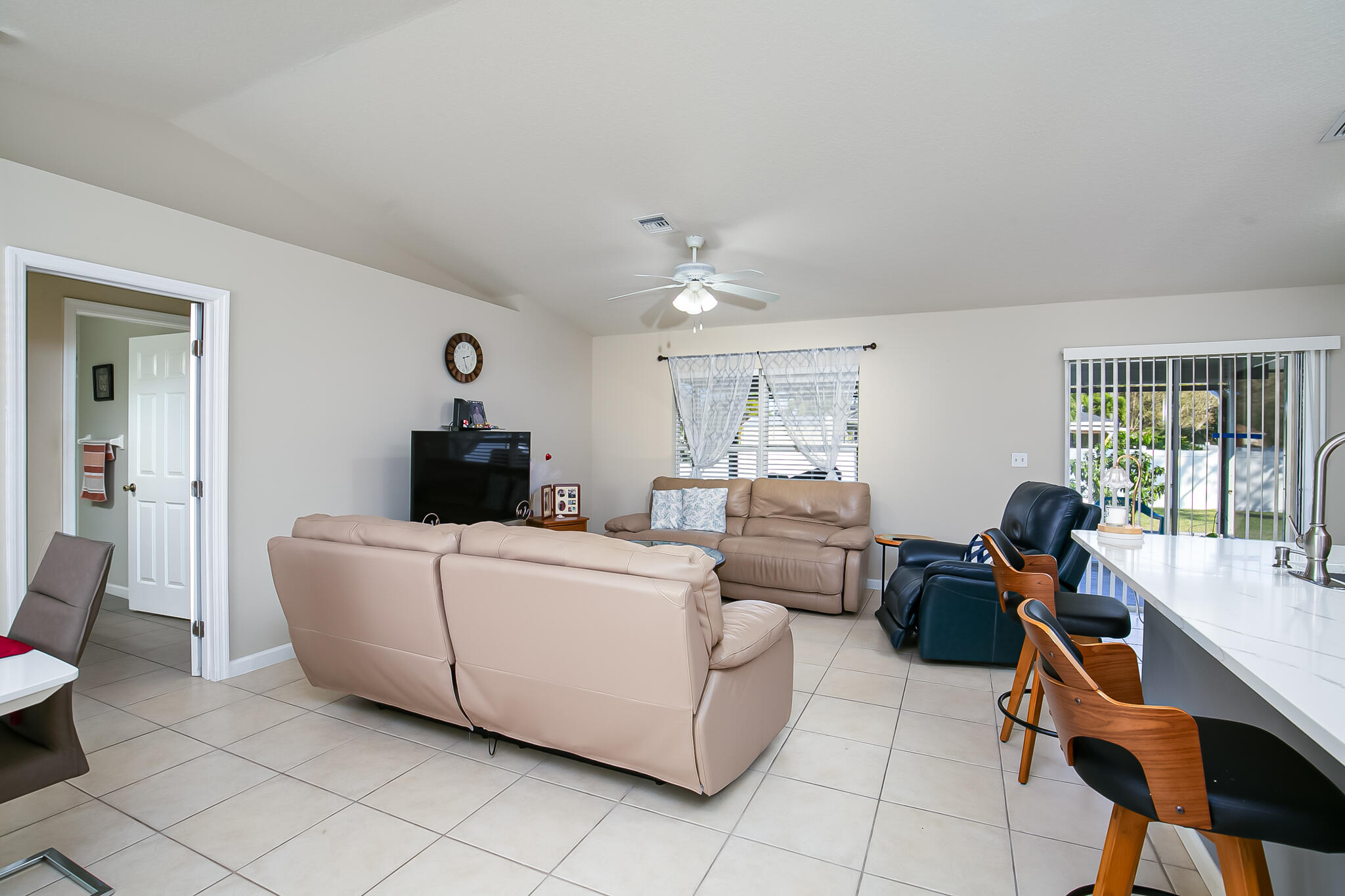 2065 Southwest Gemini Lane Port St. Lucie, FL 34984 - Photo 6 of 24 a living room with furniture a flat screen tv and a window