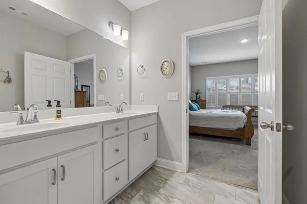 a en suite bathroom with a double sink and mirror