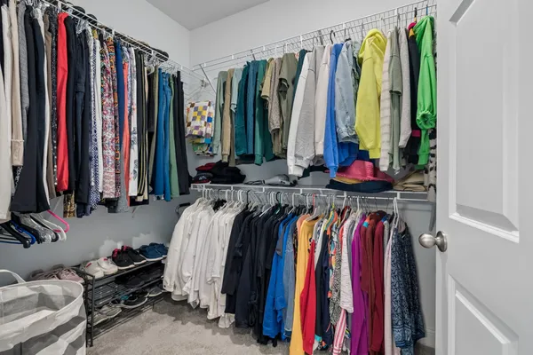 a bedroom that has a bed and a dresser in it