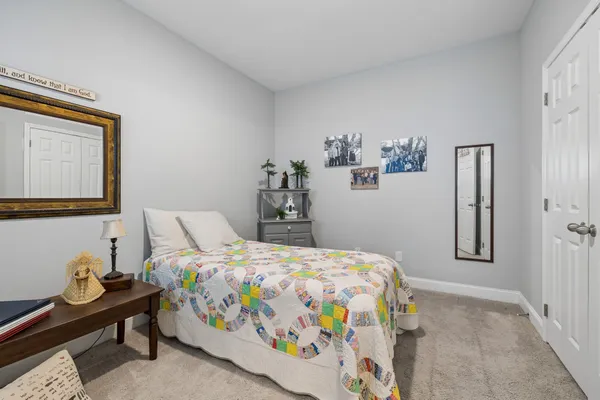 a bedroom with a bed and a mirror