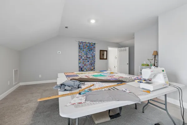 a bathroom with a toilet sink vanity and mirror