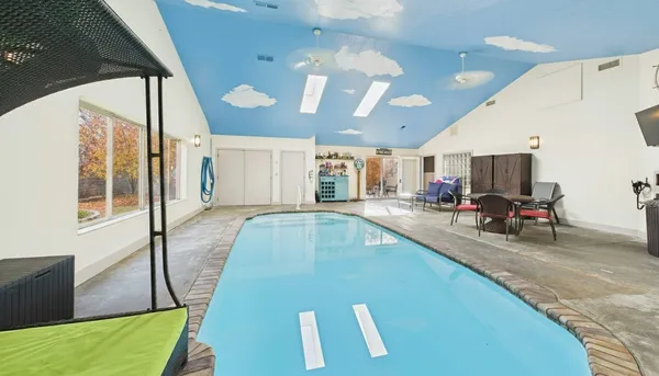an aerial view of house with yard swimming pool and outdoor seating