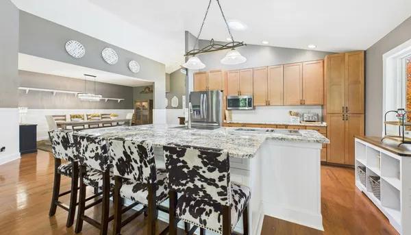 a living room with furniture a window and a painting on the wall