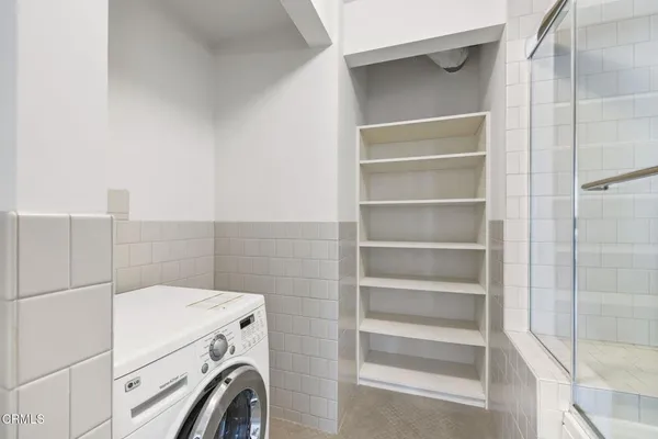 a view of storage and utility room with washer and dryer
