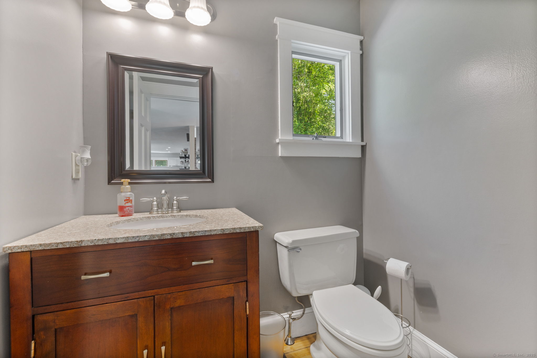 254 Haley Road Groton, CT 06355 - Photo 18 of 40 a bathroom with a toilet a sink a vanity and mirror