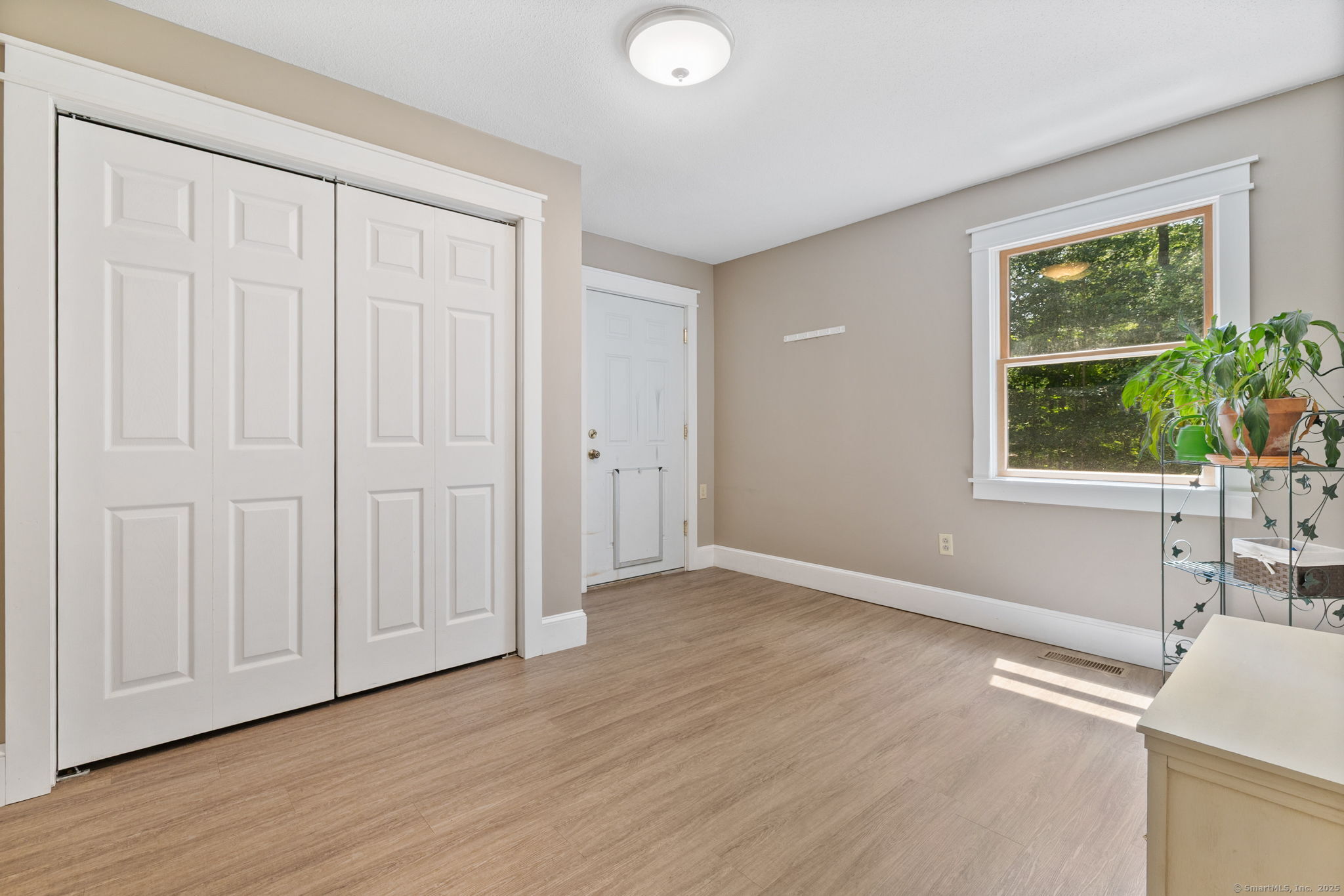 254 Haley Road Groton, CT 06355 - Photo 30 of 40 an empty room with wooden floor and windows