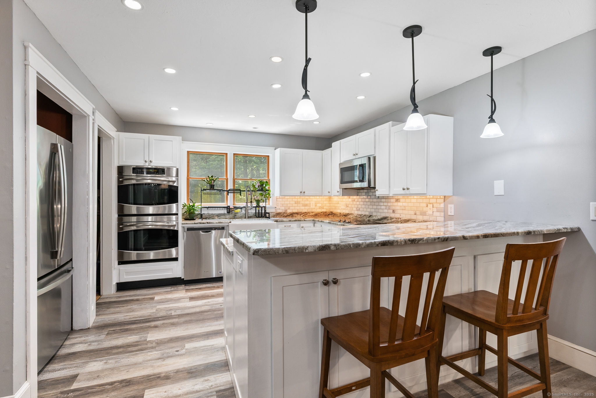 254 Haley Road Groton, CT 06355 - Photo 4 of 40 a kitchen with stainless steel appliances granite countertop a stove a refrigerator and a kitchen island