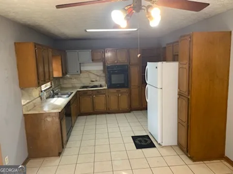 a kitchen with a refrigerator a sink and a stove