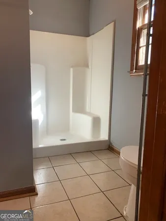 a view of an empty room with windows