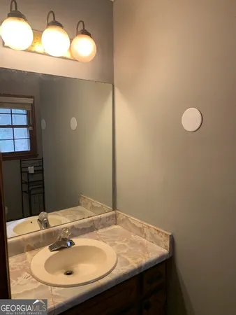 a bathroom with a sink and a mirror