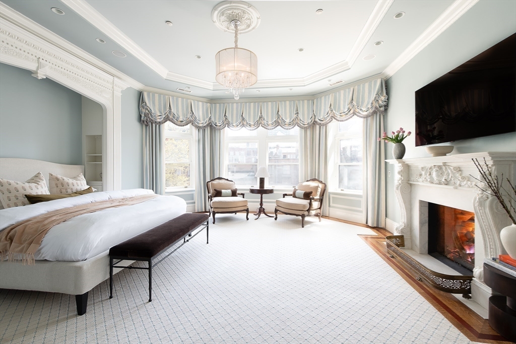 304 Commonwealth Avenue, Unit PH Boston, MA 02115 - Photo 17 of 42 a spacious bedroom with a bed and a flat screen tv