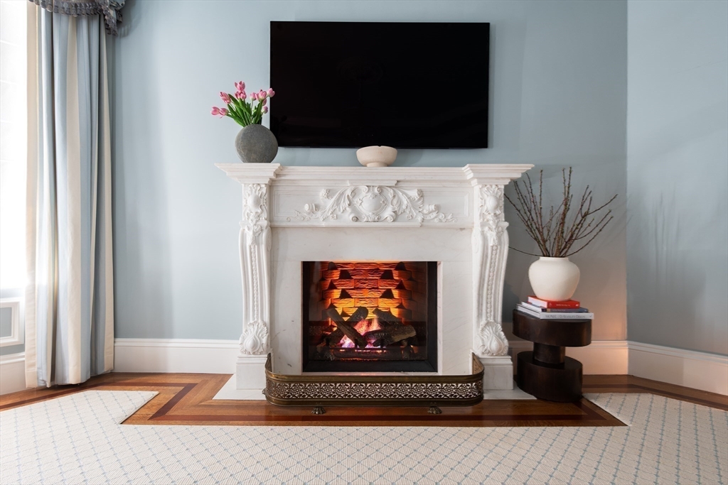 304 Commonwealth Avenue, Unit PH Boston, MA 02115 - Photo 19 of 42 a living room with furniture and a fireplace