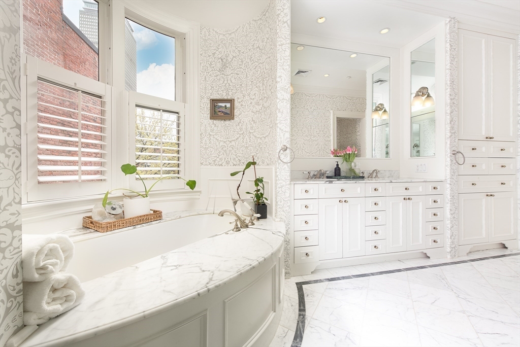304 Commonwealth Avenue, Unit PH Boston, MA 02115 - Photo 22 of 42 a bathroom with a granite countertop sink and a bathtub