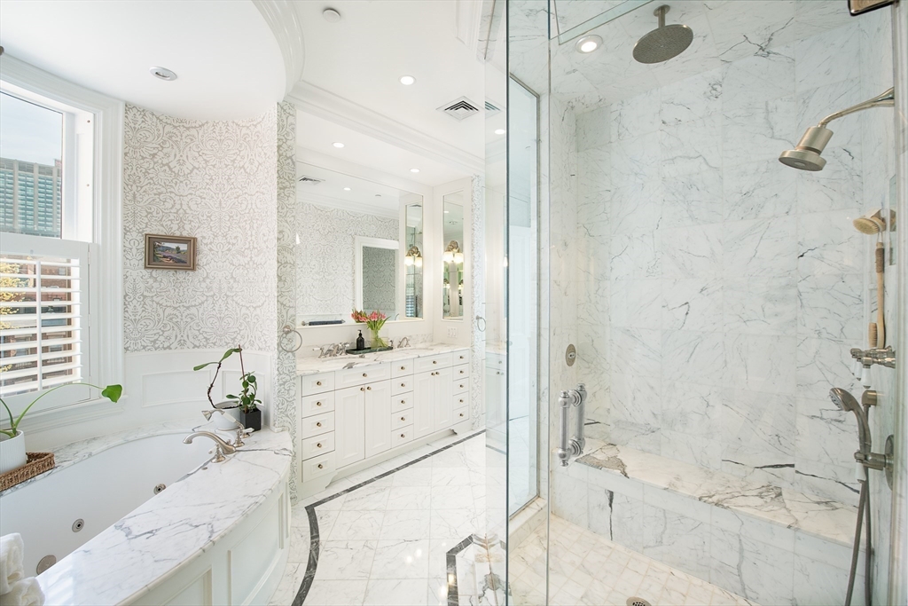 304 Commonwealth Avenue, Unit PH Boston, MA 02115 - Photo 23 of 42 a bathroom with a tub sink and mirror