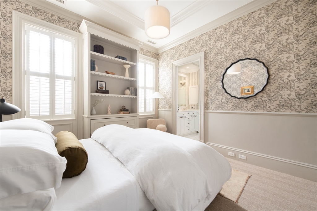 304 Commonwealth Avenue, Unit PH Boston, MA 02115 - Photo 25 of 42 a bedroom with a large bed and a large window