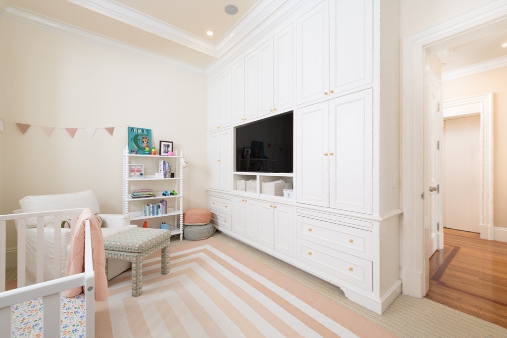 304 Commonwealth Avenue, Unit PH Boston, MA 02115 - Photo 30 of 42 a living room with furniture and a flat screen tv