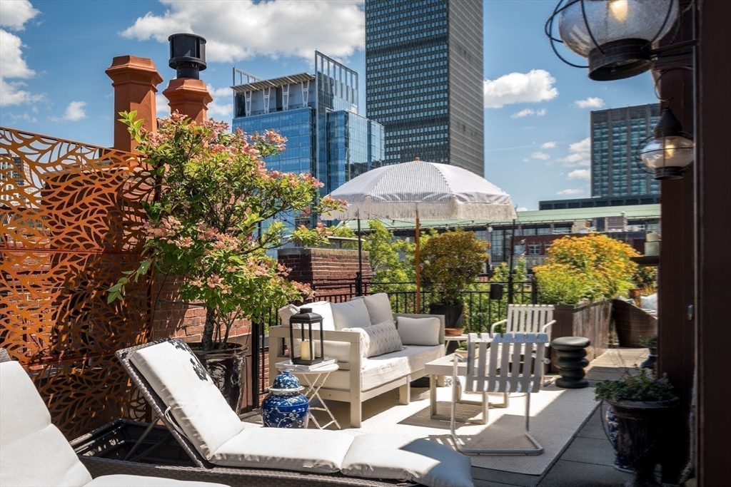 304 Commonwealth Avenue, Unit PH Boston, MA 02115 - Photo 36 of 42 a patio with tables and chairs