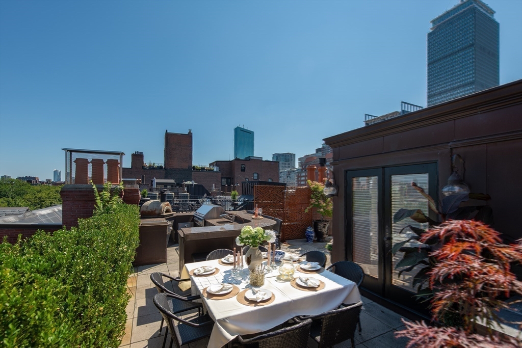 304 Commonwealth Avenue, Unit PH Boston, MA 02115 - Photo 39 of 42 a view of a dinning tables and chairs in patio