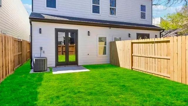 a view of a house with brick walls and a yard with stairs