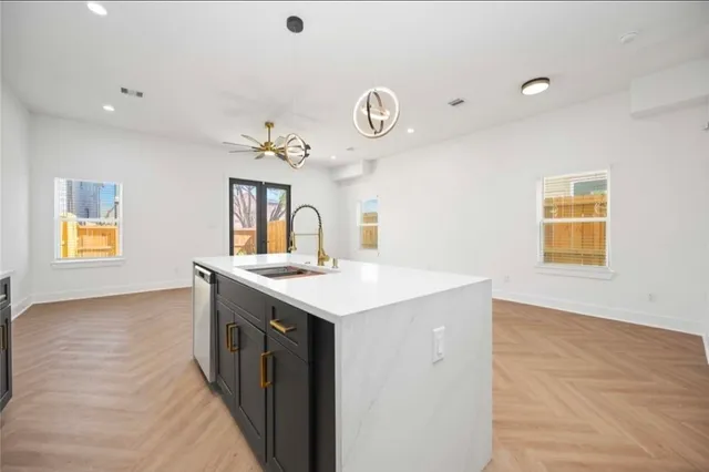a kitchen with a sink cabinets and a window