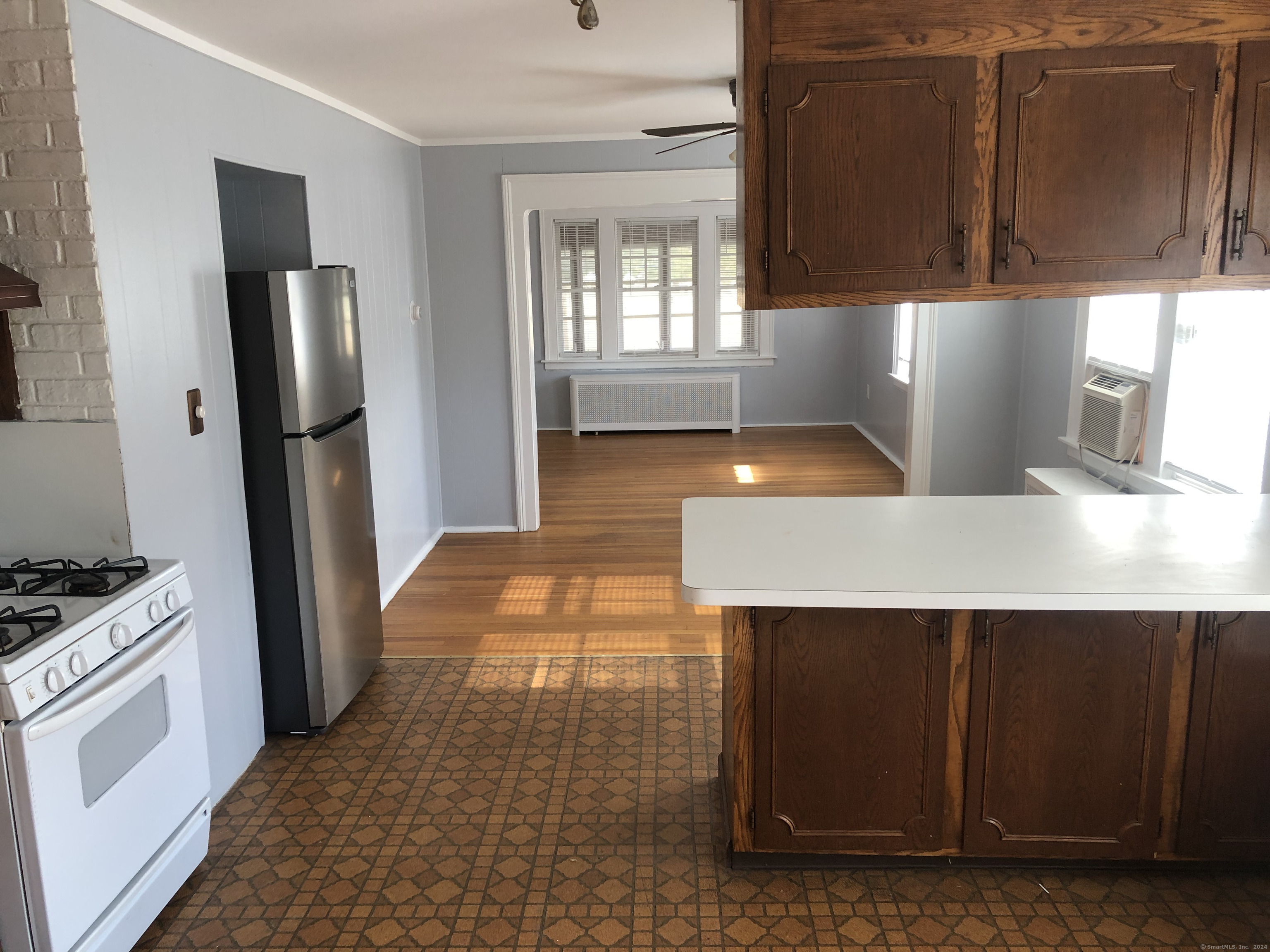 317 Garden Street Wethersfield, CT 06109 - Photo 3 of 14 a kitchen with stainless steel appliances a refrigerator a stove a microwave and white cabinets