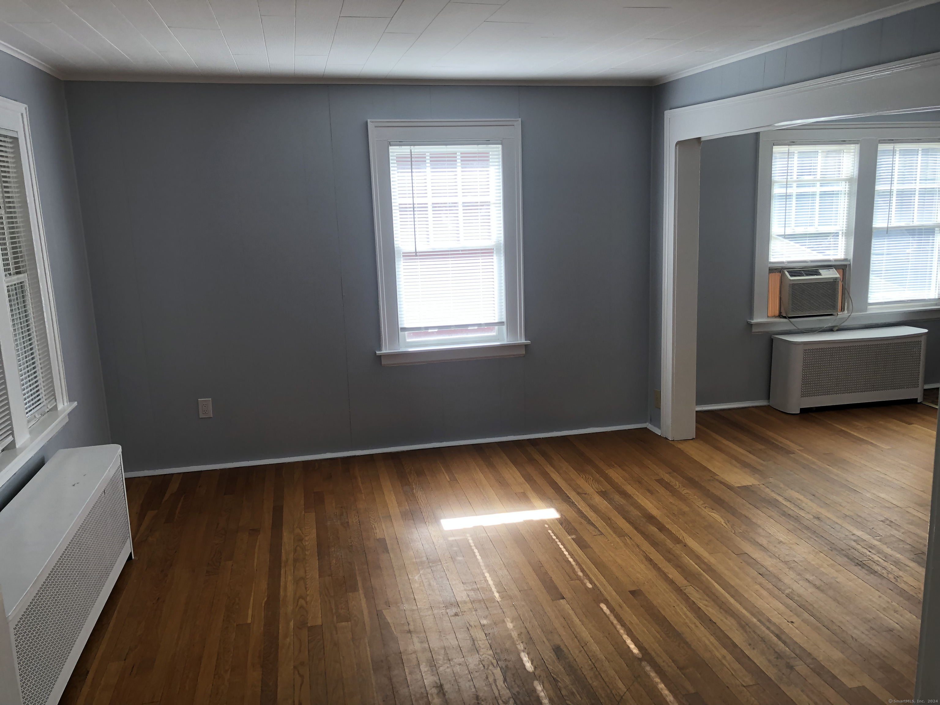 317 Garden Street Wethersfield, CT 06109 - Photo 5 of 14 a view of an empty room with wooden floor and a window
