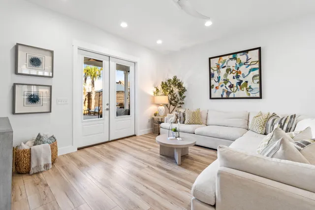 a living room with furniture and a potted plant