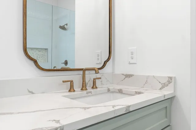 a bathroom with a double vanity sink and mirror