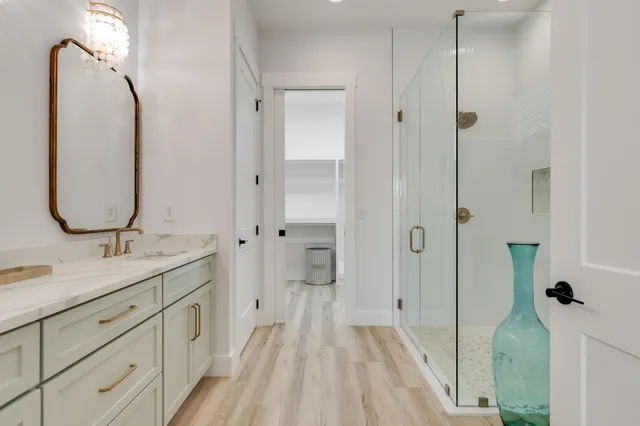 a bedroom with a bed a flat screen tv and a window