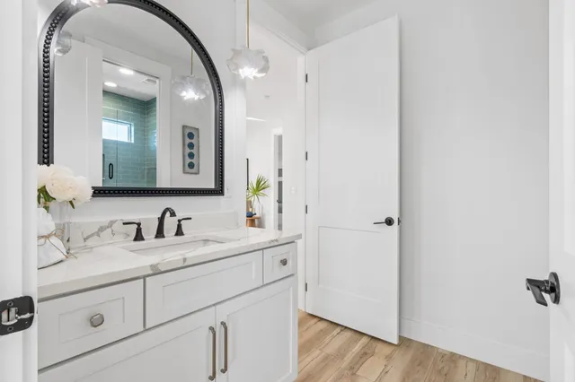 a bathroom with a double vanity sink a mirror and a shower