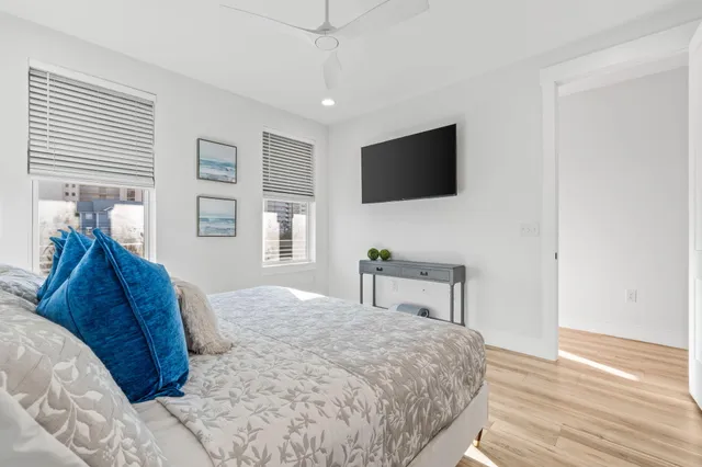a bedroom with a bed and a view of living room