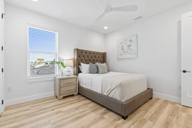 a living room with furniture and a ceiling fan