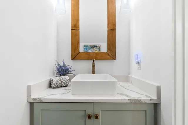 a kitchen with stainless steel appliances granite countertop a sink a stove and a wooden floors