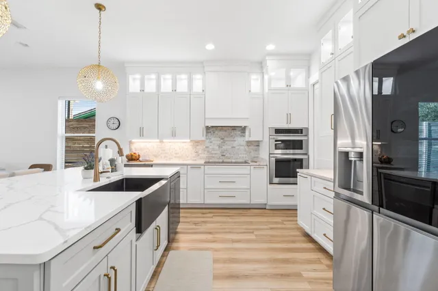 a bathroom with a granite countertop sink a toilet and mirror