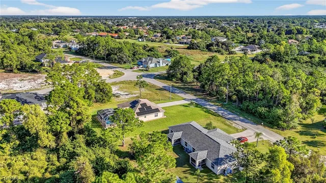 an aerial view of a house with a yard