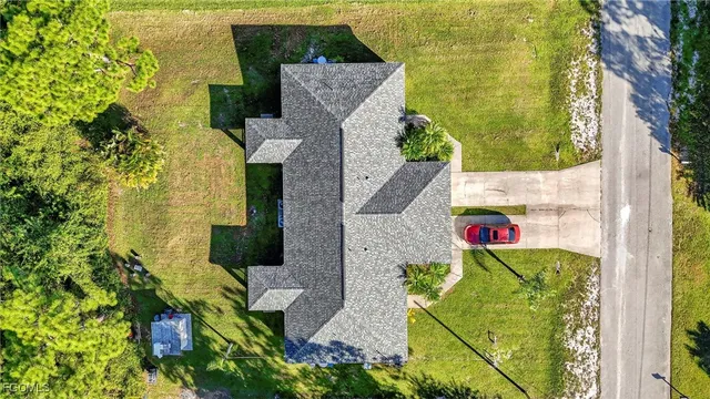 an aerial view of a houses with a yard
