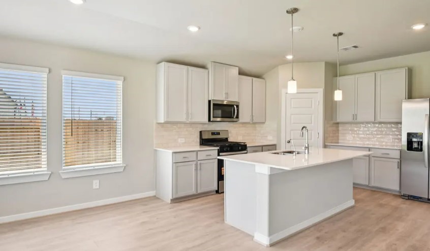 1652 Hopson Ranch Drive Conroe, TX 77301 - Photo 2 of 14 a kitchen with a sink stove top oven and refrigerator