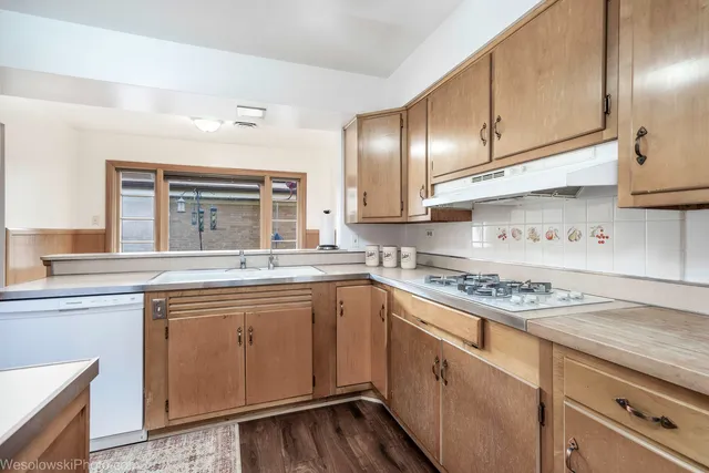 a kitchen with stainless steel appliances granite countertop a stove sink and cabinets