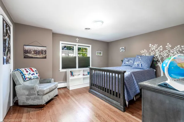 a bedroom with furniture and a large window