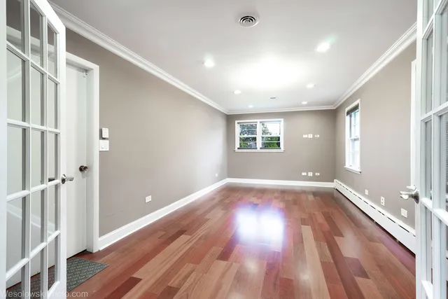 wooden floor in an empty room with a window
