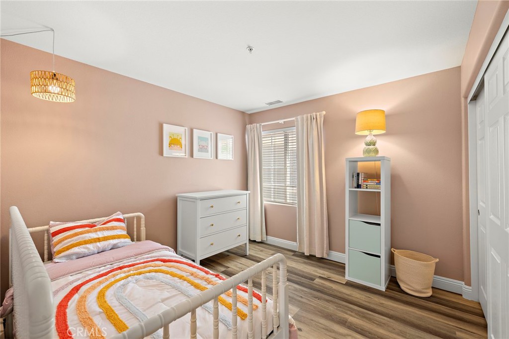 71 Sklar Street Ladera Ranch, CA 92694 - Photo 26 of 55 a bedroom with a bed and wooden floor