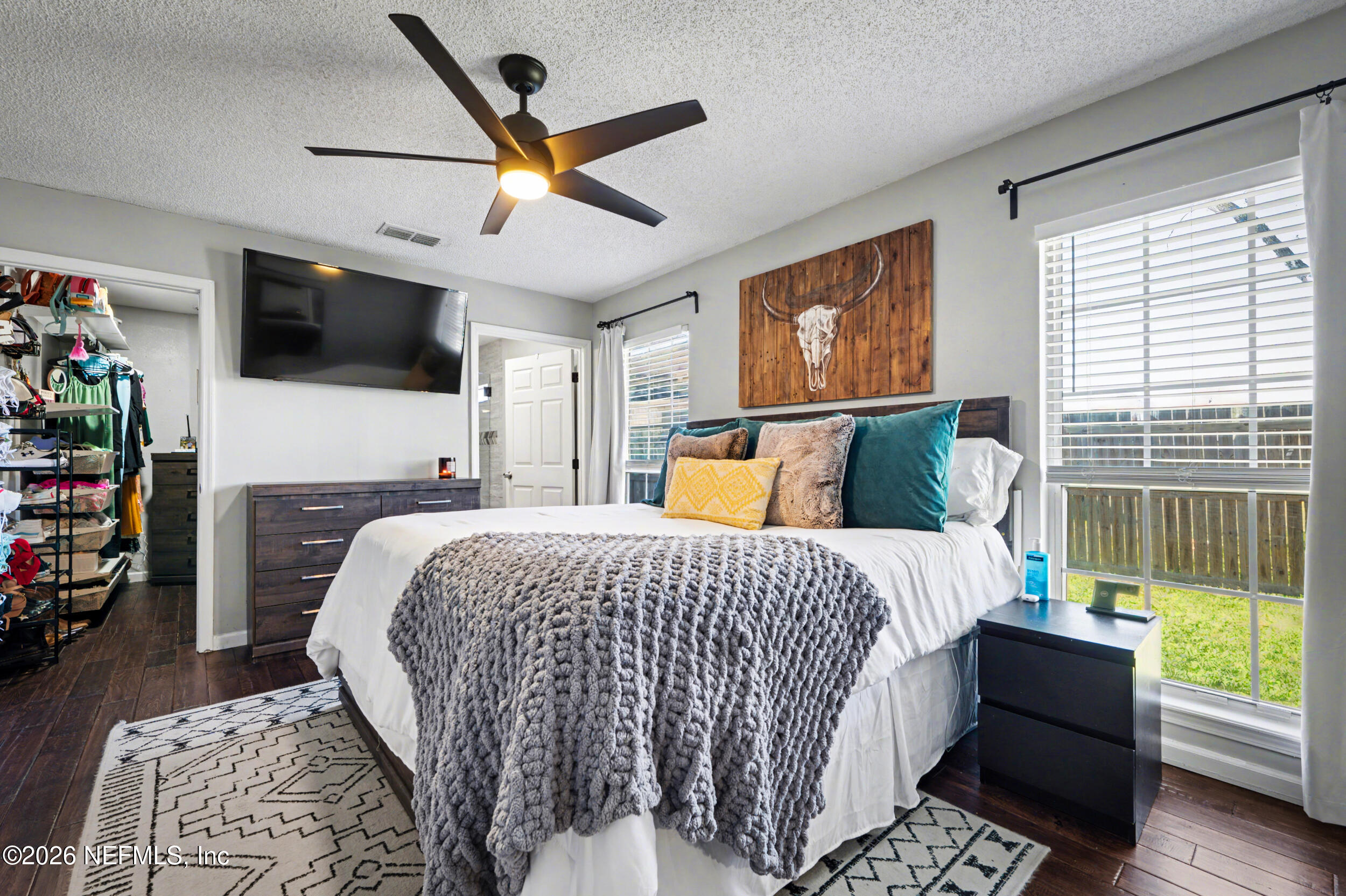 2992 Quapaw Trail Middleburg, FL 32068 - Photo 13 of 32 a bed room with a bed a television and a window