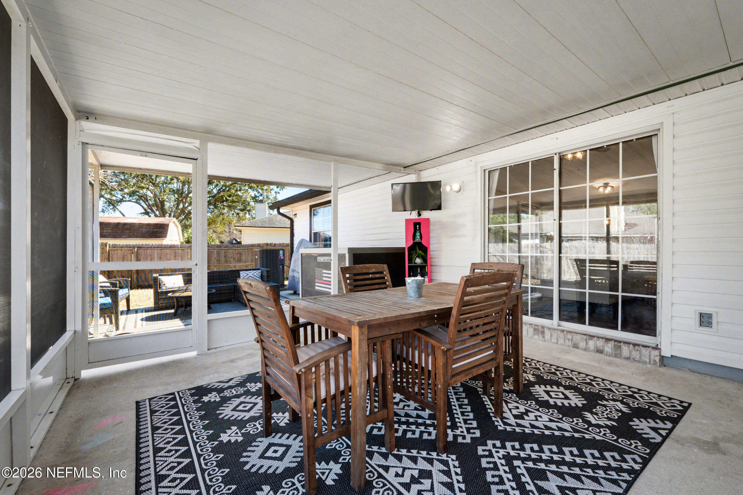 2992 Quapaw Trail Middleburg, FL 32068 - Photo 26 of 32 a dining room with furniture a rug and a floor to ceiling window