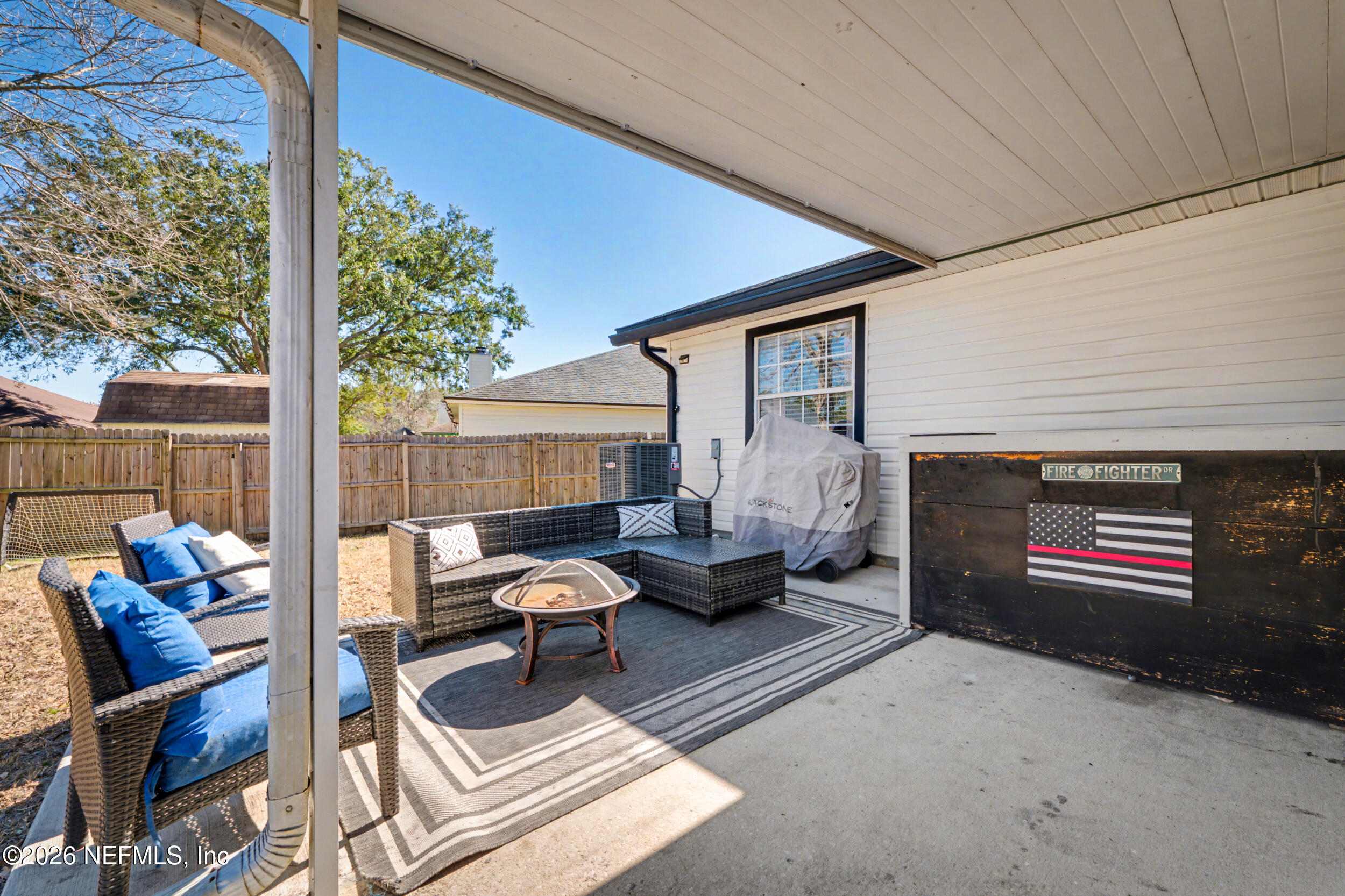 2992 Quapaw Trail Middleburg, FL 32068 - Photo 27 of 32 a outdoor living space with patio furniture and a fireplace